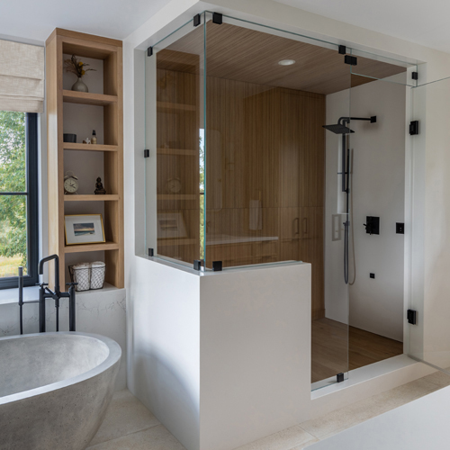 Native Trails tub with black fixtures and gray Porcelanosa tile in Boulder home